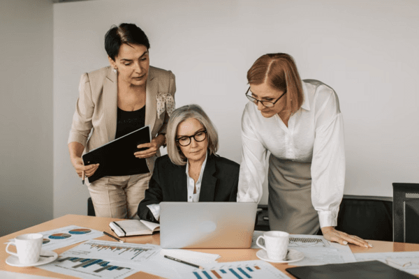 Women-led consulting team collaborating on business data and Zoho strategy